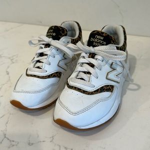 Girls New Balance white with cheetah details sneakers.